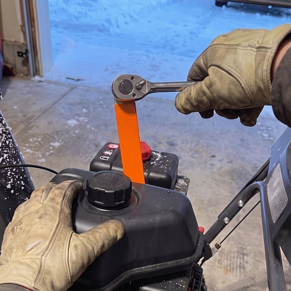 The offset slid down past a snowblower fuel tank onto a bolt below it